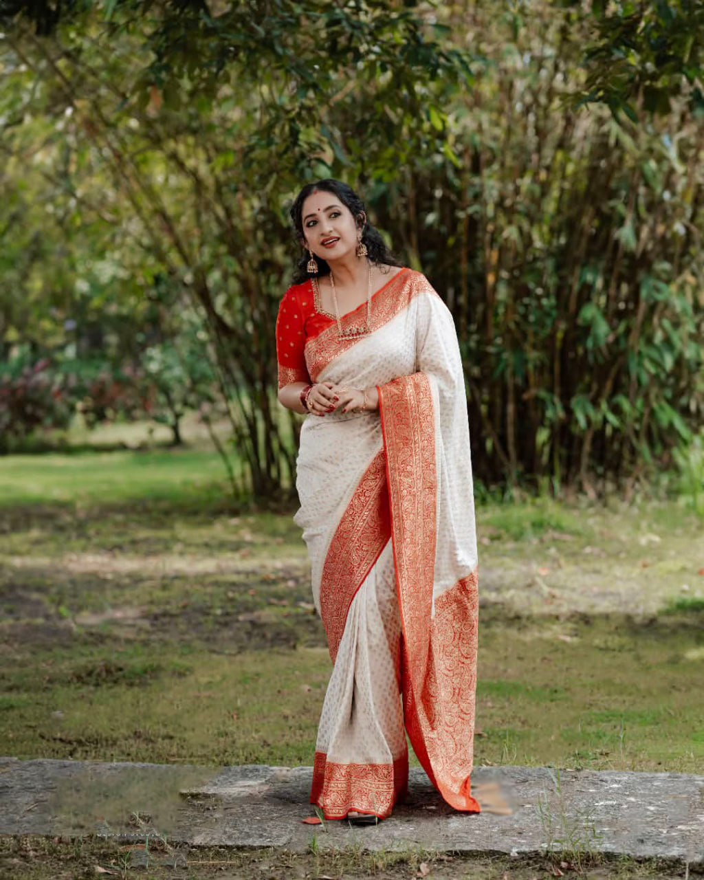 Elegant White Saree with Red Border and Gold Detailing