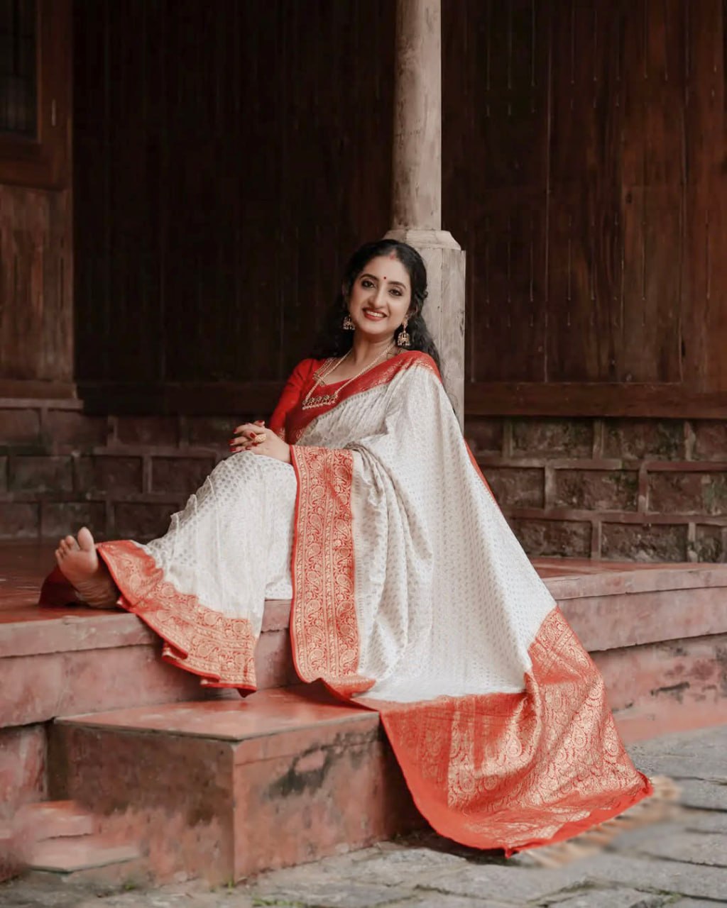 Elegant White Saree with Red Border and Gold Detailing