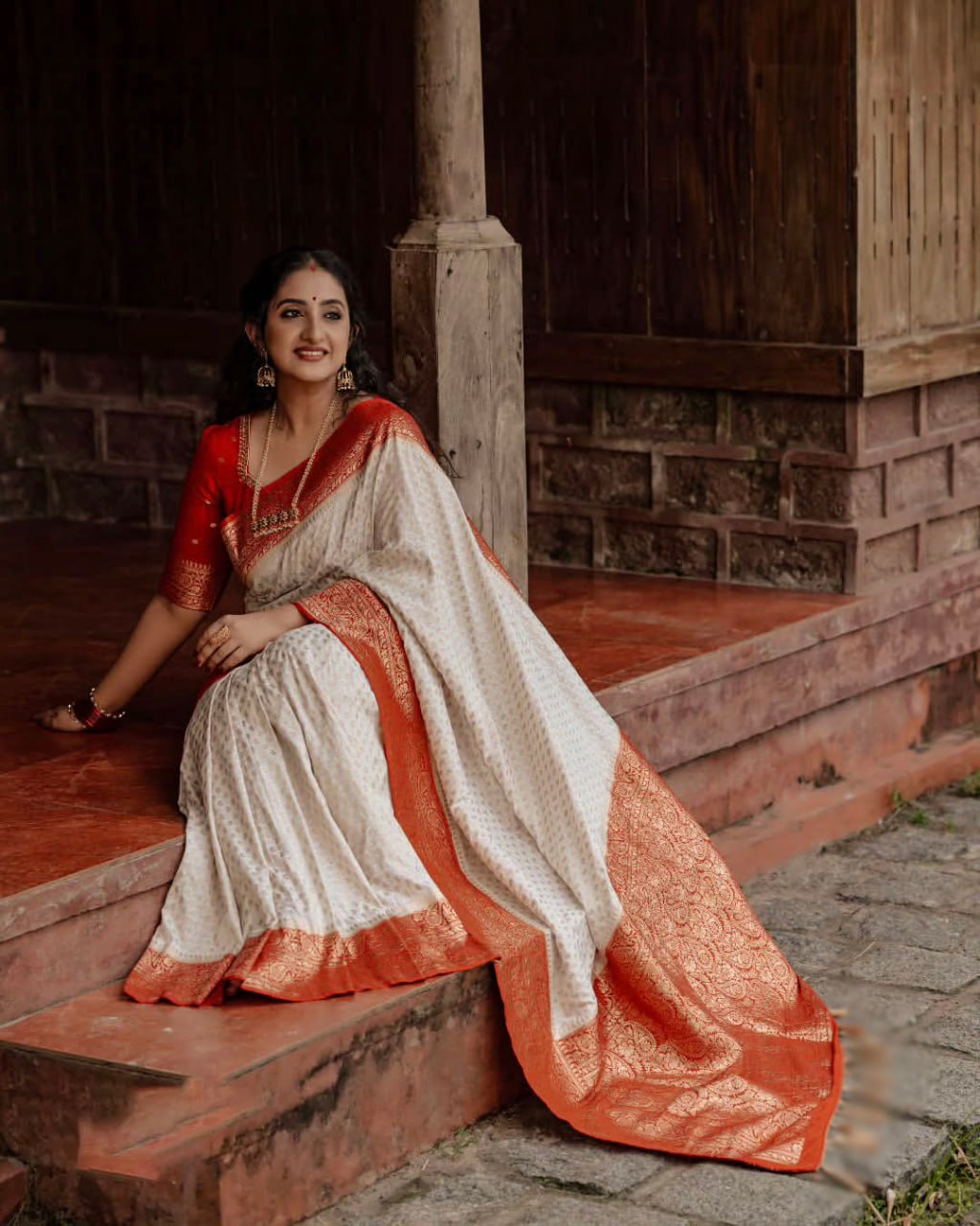Elegant White Saree with Red Border and Gold Detailing