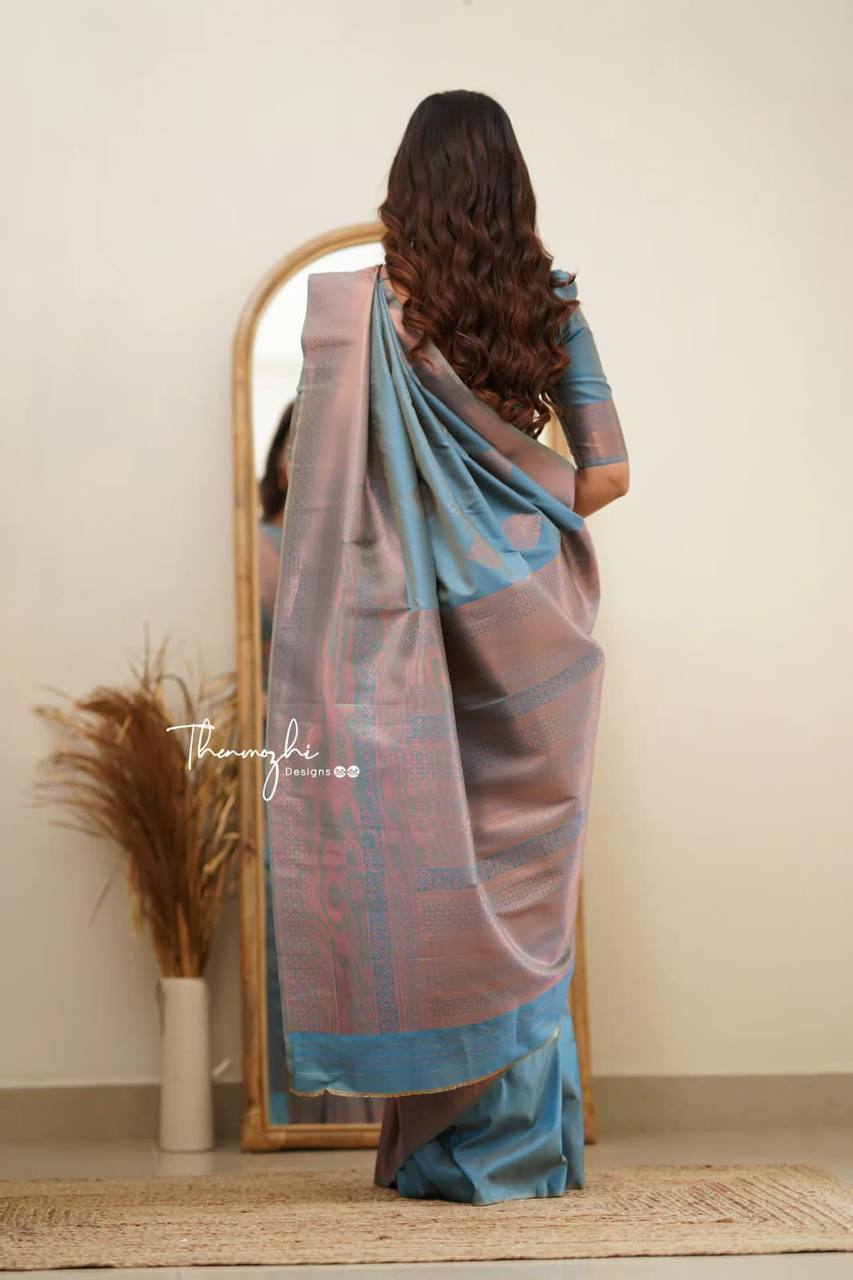 Elegant Blue Silk Saree with Pink Border and Floral Motifs