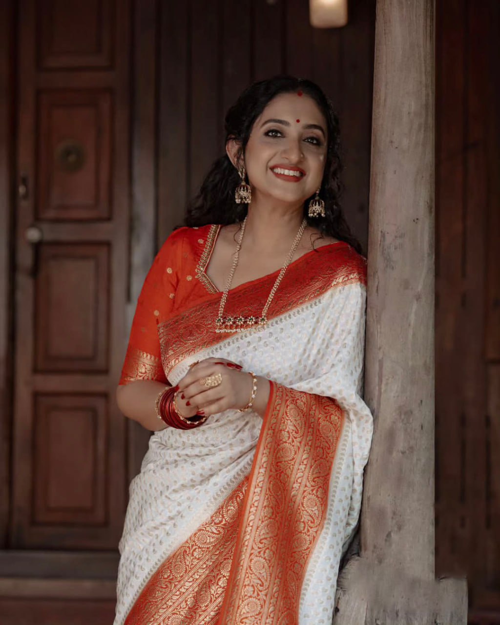 Elegant White Saree with Red Border and Gold Detailing