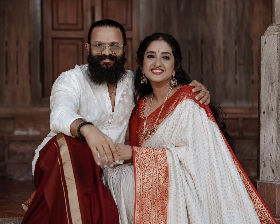 Elegant White Saree with Red Border and Gold Detailing