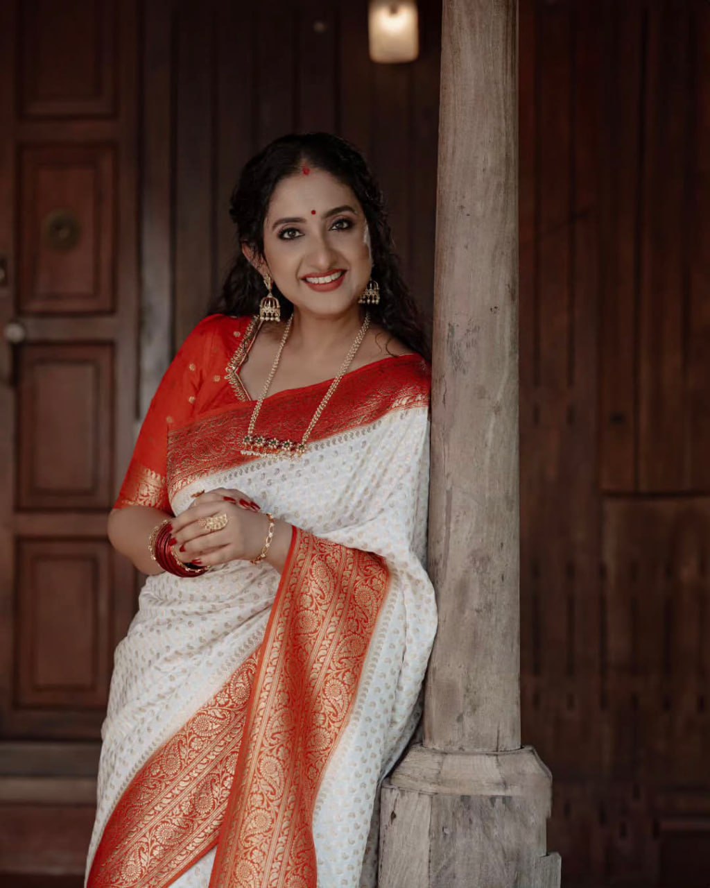 Elegant White Saree with Red Border and Gold Detailing